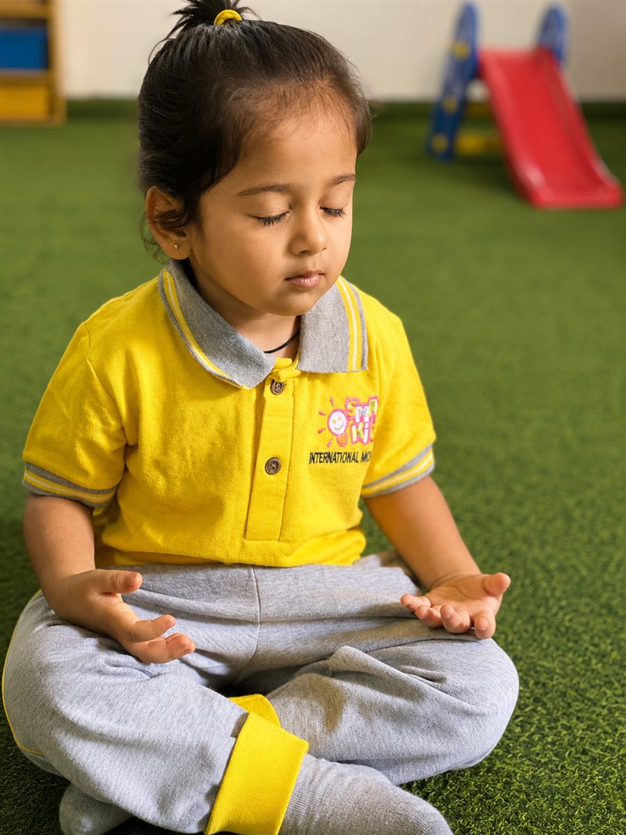 A child sitting calmly in meditation at Smartkids